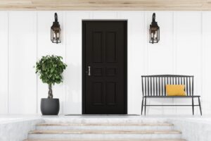 Stylish black front door of modern house with white walls, door mat, tree in pot, black bench, stairs and lamps. 3d rendering